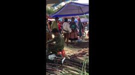 Loud fierce argument in Vietnamese market between hilltribe woman and market seller who threatened her with a knife