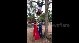 Photographer hangs upside down for perfect wedding shot