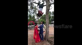 Photographer hangs upside down for perfect wedding shot