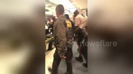 Moment man who 'groped passenger' on Miami flight taken away by airport police