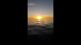 Red rich sunset  from water level and below