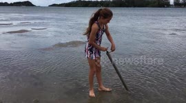Young Australian girl shows how to catch nippers for fishing bait