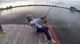 Watch a man reel in a monster catfish in Thailand