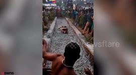 A priest suffers 60 per cent burns after he fell over - while running across hot coals