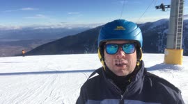 Man skiing in Bansko in the Pirin Mountains - Footage from the top of Banderitza 2 - Skiing