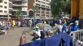 Survivors live in tents next to Sao Paulo tower as it still smoulders