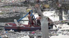 Workers tackle plastic pollution plaguing Philippines river for half a century
