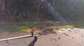 Lava spews from side of cracked road in Hawaii