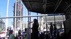 Lady on stage preaches to the cheering crowd about banning abortion Parlement square london by jim connor