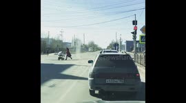 Dust devil chases old lady across street in Russia