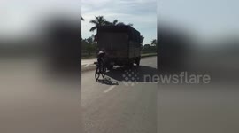Cyclist desperate to avoid headwind positioned dangerously close to truck