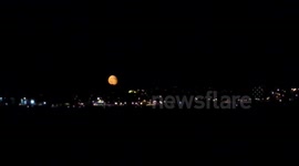 Red moon rising  over plymouth