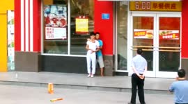 Man holds a person with knife