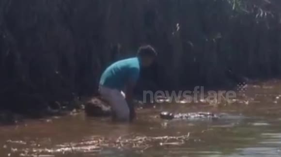 Man kisses huge wild crocodile