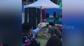 Bizarre footage shows fist fight between pink-haired man and thong-clad fellow reveller at gay pride festival