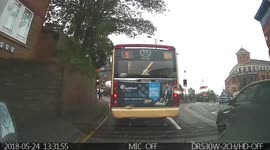 Bus breaking red light a girl about to cross. Then blocked the crossing
