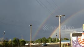 Rare occurence in the Denver sky 2 rainbows overlooking lakeside amusement park on the east side of denver