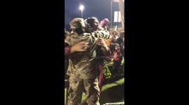 Woman arrives from army posting overseas to surprise little sister at graduation