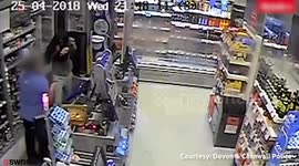 Brave female shop worker fights off armed robber