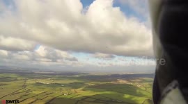Moment paragliders come just 20m from disaster as 345mph-Royal Navy Hawk passed by super close.