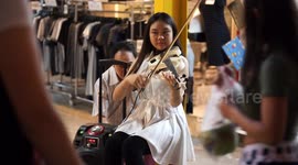 Beautiful talented street busker, in Bangkok, Thailand.