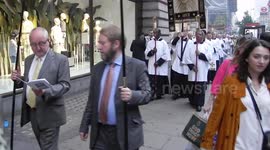 Oxford street London religious pilgrims priest vicars alter boys quire band and people heading along the street singing hymns as they go by Jim Connor