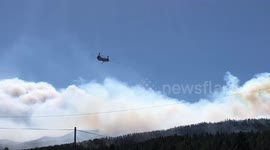 Helicopter races toward smoke-filled forest to battle massive New Mexico fire