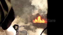 Videographer films lava fountain in Hawaii's Kilauea from the edge of a helicopter
