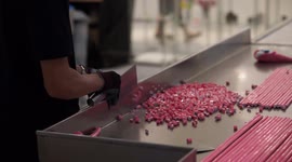 Thai worker cuts rock candy with machine-like efficiency
