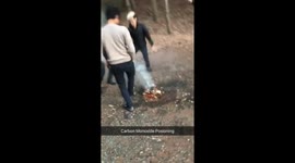 CULT GATHERING AROUND CAMPFIRE