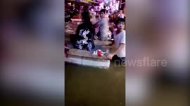 Man charges Chinese commuters to cross flooded road on DIY boat made of foam