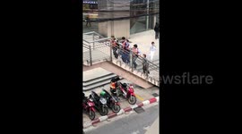 Newsflare Edit - Passers-by lift disabled man in wheelchair up stairs