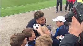 Dele Alli signs footballs and takes selfies with Russian kids