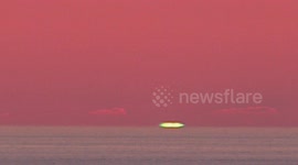 Mesmerising green ray appears in the sunset sky in northern Spain