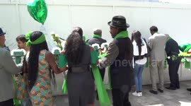 Humanity 4 Grenfell white flowers being laid at the foot of Grenfell Tower