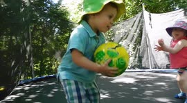 Two Toddlers Aged Two Jumping On A Trampoline