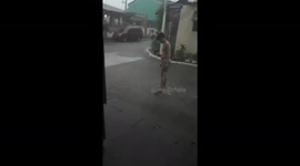 Teenager Plays Basketball Through Storm