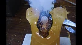 Watch as a red hot nickel ball melts straight through a giant gummy bear