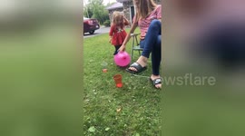 Adorable little girl pops balloon only to fall flat on her face