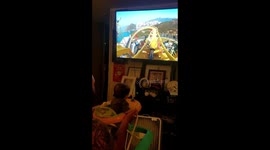 Dad plays virtual roller-coaster game with baby