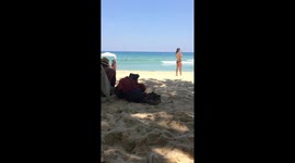 People hiding from the sun at the beach