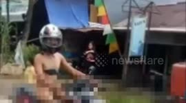 an Indonesian man Traveling around the city with a naked so spectacle of the citizens