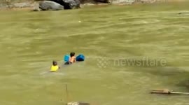 Students in Toraja struggle to cross the swift river to school
