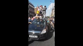 England fans seen jumping on cars in London’s Shoreditch