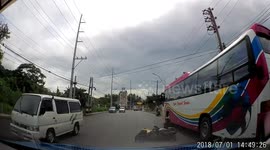 Motorcyclist and passenger inches from falling under bus wheels
