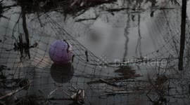 Childs ball floating in polluted water
