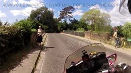 Cyclist runs across road on a bend in front of motorbike near Cambridge