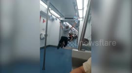 Chinese man does gymnastics on train