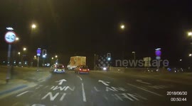 Caught on dashcam: A young lad leans from the back seat across a passenger through the front window to vomit down the side of his friends car.