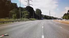 Man takes dog for a walk down hard shoulder